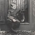 A small boy with a Scottish Terrier
